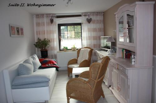 a living room with a couch and chairs at Romantik Landhaus in Dresden