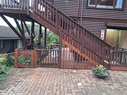 a wooden staircase leading to a building with a deck at Townhouse at Eagles Nest, Southport, KZN south coast in Port Shepstone
