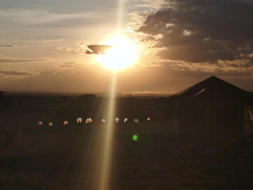 a sunset with the sun in the sky at Infinity Camp Grounds Maanzoni Backpackers in Kenplains