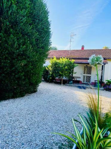 a house with a gravel driveway in front of it at JESSICA&JASMIN alloggio turistico in Fiumicino