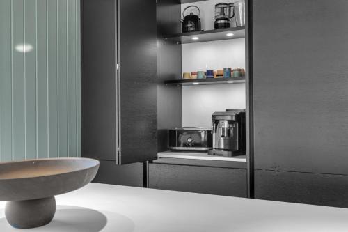 a kitchen with a sink and a microwave at mosaberg,is in Selfoss