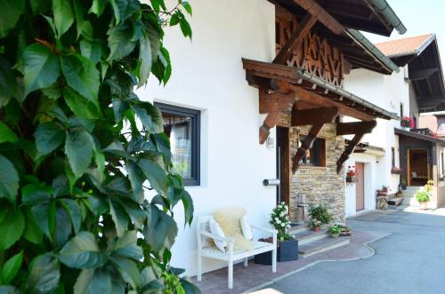 a porch of a house with a white chair at Bettina in Ehrwald
