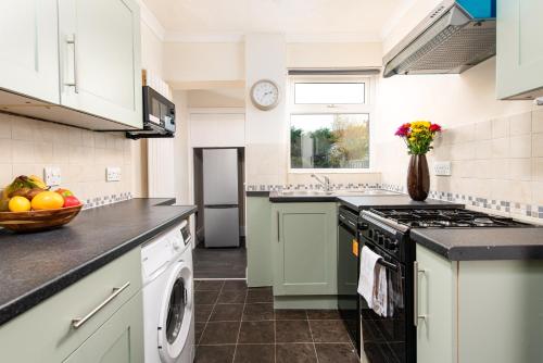 a kitchen with a sink and a stove top oven at Long Stays-4bed house-Parking-By FabAccommodation in Bristol