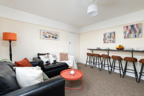 a living room with a couch and a table at Long Stays-4bed house-Parking-By FabAccommodation in Bristol