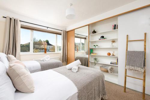 a bedroom with two beds and a window at Long Stays-4bed house-Parking-By FabAccommodation in Bristol