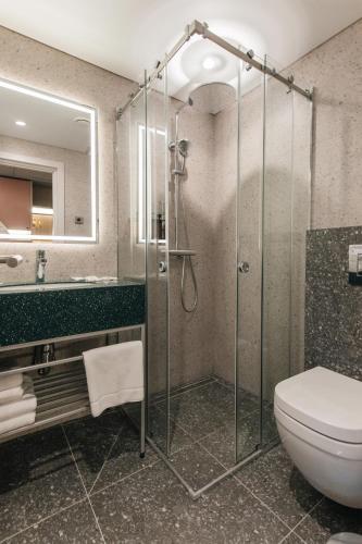 a bathroom with a glass shower and a toilet at Yourta in Oral