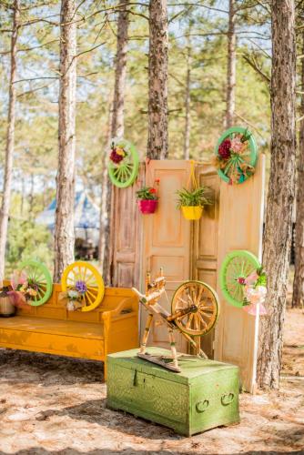 a wooden bed with flowers on it in a forest at Moncastro Glamping in Vylkove