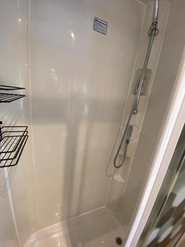 a white shower with a glass door in a bathroom at Island Retreat in Sandown