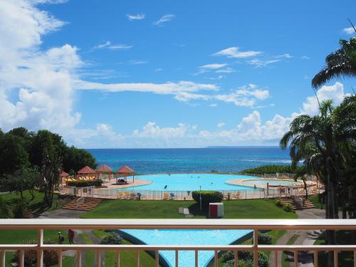 a view of the pool from the balcony of a resort at Holidays Guadeloupe -Paradise -Anse des Rochers in Belle-Allée