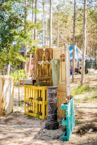 a pile of equipment in a field with trees at Moncastro Glamping in Vylkove
