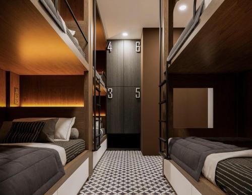two beds in a room with bunk beds at TN Hue Dorm in Hue
