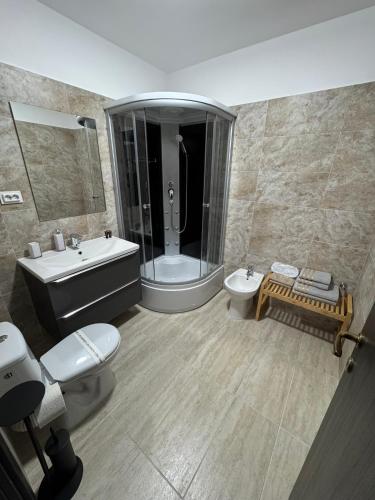 a bathroom with a tub and a toilet and a sink at 1 Mai - Luxury Park Apartments - Self check-in - Private parking 3 in Craiova