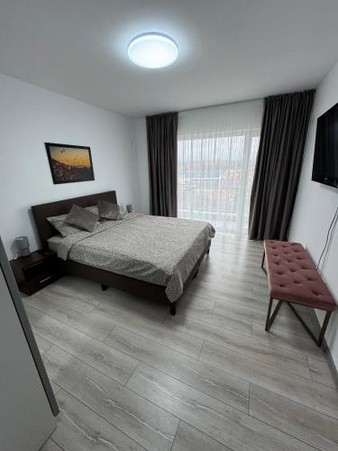 a bedroom with a bed and a large window at 1 Mai - Luxury Park Apartments - Self check-in - Private parking 3 in Craiova