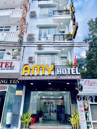a building with aany hotel sign in front of it at Amy Hotel Hue in Hue