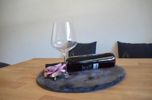 a bottle of wine and a glass on a table at Bettina in Ehrwald