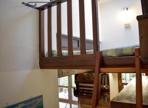 a wooden staircase in a room with a window at Dépendance Viburni in Alghero