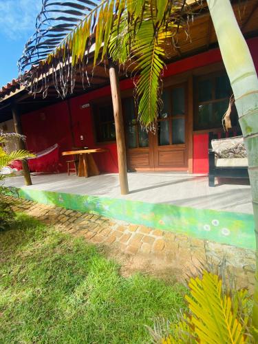 a house with a bench in front of it at Pousada Destino in Porto de Sauipe