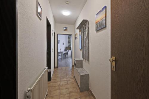 a hallway with a stairway leading to a room at Hotel Hülsmann Garni in Niedersachsen-Stadland