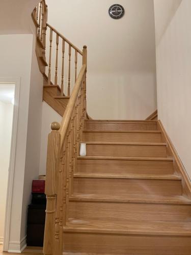 a staircase in a home with wooden steps at Fresh Home in Oshawa