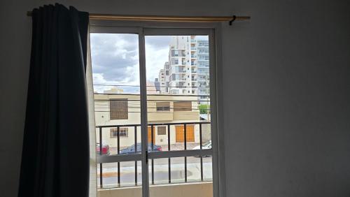 a window with a view of a building at Vida, hotel de playa in Puerto Madryn