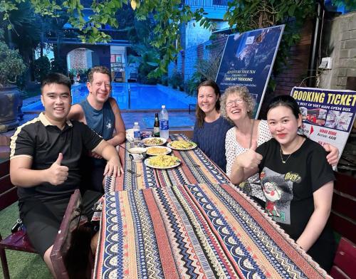 a group of people sitting around a table at The Ridge Haven in Phong Nha