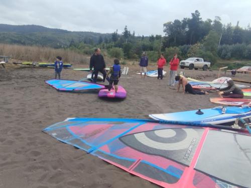a group of people on a beach with kites at Vichuquen Lodge y Marina in Vichuquén