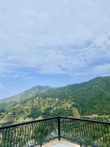 a balcony with a view of a mountain at Entire Holiday Home in Galiyat with Valley Views in Khaira Gali