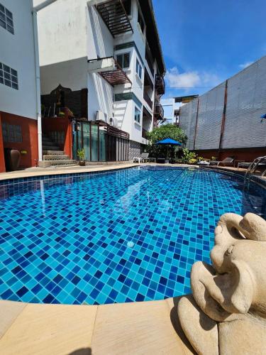 a large blue swimming pool in a building at The Album Loft in Patong Beach