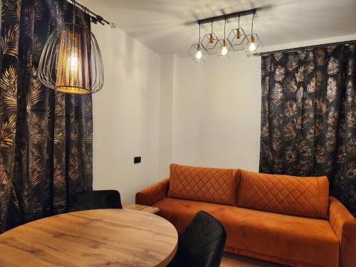 a living room with a couch and a table at New! Warsaw Luxury Apartment with Jacuzzi and total relax - Warszawski Luksus Jacuzzi i totalny relaks! in Warsaw