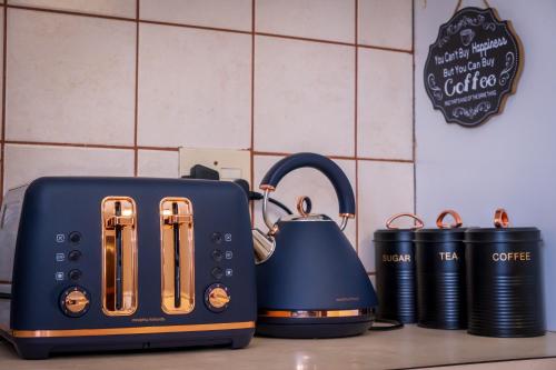 a toaster and a tea kettle on a kitchen counter at High Court Self Catering Apartments in Nelspruit