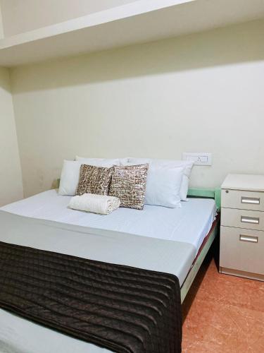 a bed with two pillows on it in a room at VILLA CALATHEA Varkala in Varkala