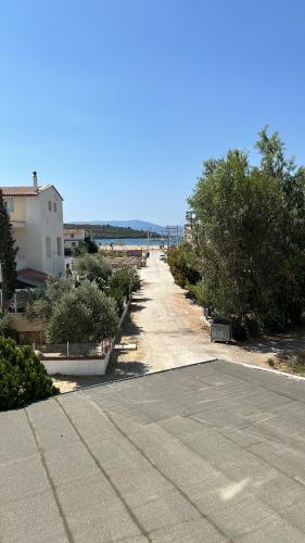 an empty parking lot with trees and bushes at Grand asia otel in Seferihisar