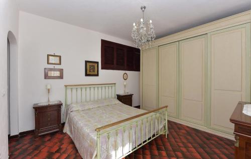 a bedroom with a bed and a chandelier at Casa Barbara in Amalfi