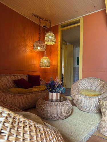 a living room with wicker chairs and a table at Ancestros in La Paloma