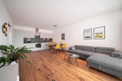 a living room with a couch and a table at Apartment Caldara 4 in Pianizza di Sotto