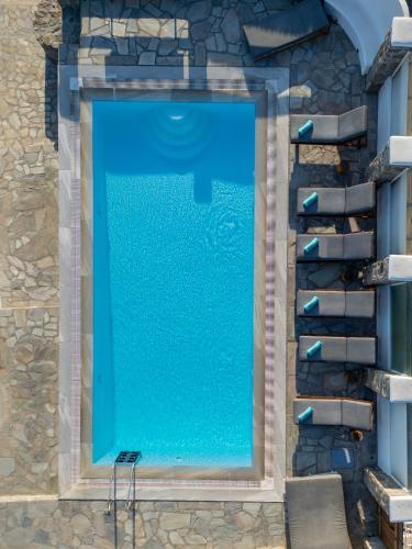 an overhead view of a swimming pool with blue water at Mando Pool Villas w Sea Views - Five Bedrooms in Super Paradise Beach