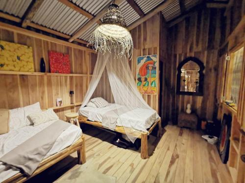 Postel nebo postele na pokoji v ubytování Papaya Lodge
