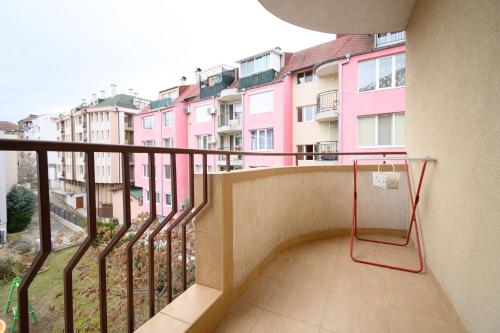 a balcony with a view of some pink buildings at Cozy 2BDR & Peaceful Location & Free Street Parking in Blagoevgrad
