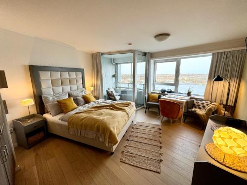 a bedroom with a large bed and a room with a desk at Schleiblick in Schleswig