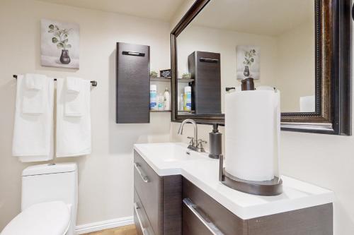 a bathroom with a sink and a toilet and a mirror at Rancho Retreat in Rancho Cucamonga