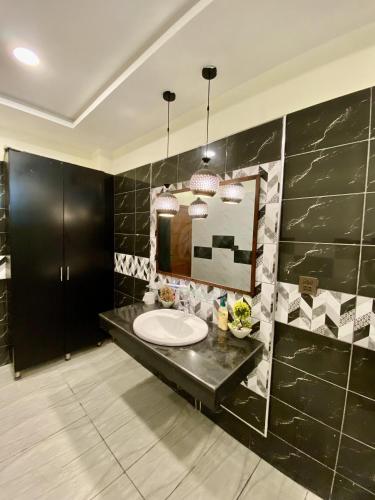 a bathroom with a sink and a mirror at Entire Holiday Home in Galiyat with Valley Views in Khaira Gali