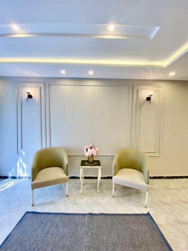 two chairs and a coffee table in a room at Entire Holiday Home in Galiyat with Valley Views in Khaira Gali