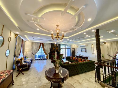 a living room with a chandelier on the ceiling at Entire Holiday Home in Galiyat with Valley Views in Khaira Gali