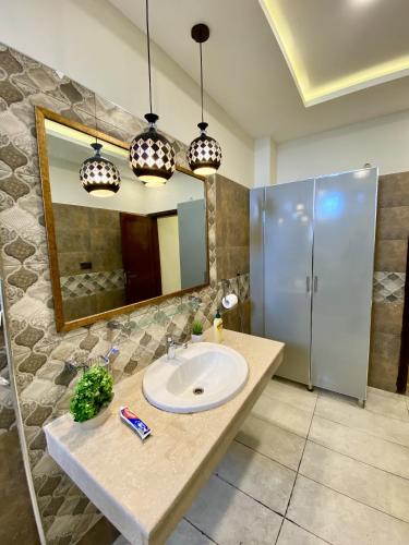 a bathroom with a sink and a mirror at Entire Holiday Home in Galiyat with Valley Views in Khaira Gali