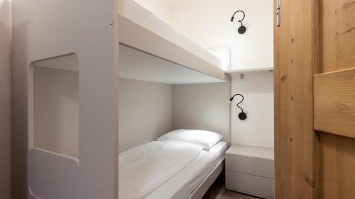 a small bedroom with a bed in a room at Apartments Hofgarten in Caldaro