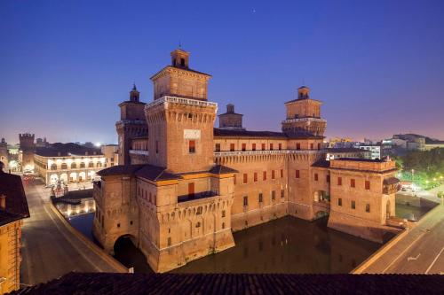 a large building with two towers on top of it at EGO' Residence Ferrara in Ferrara
