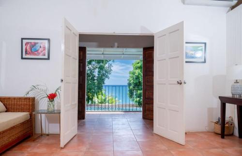 a living room with a door leading to a balcony at Culloden Cove in Whitehouse