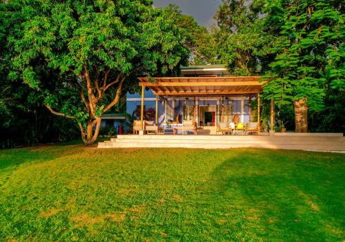 a house with a pavilion in the middle of a yard at Culloden Cove in Whitehouse