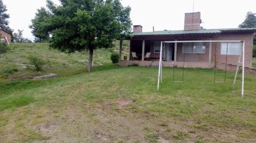 an empty yard in front of a house at El Campito casa frente al río in Villa Carlos Paz