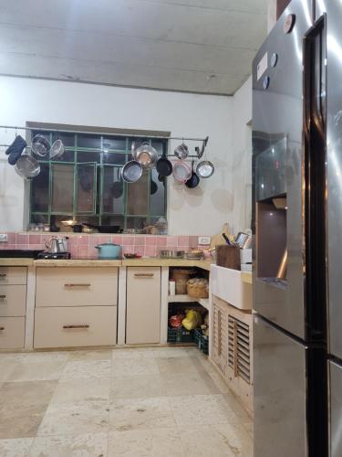 a kitchen with a stainless steel refrigerator at בקתה וטבילה במדבר in H̱aẕeva